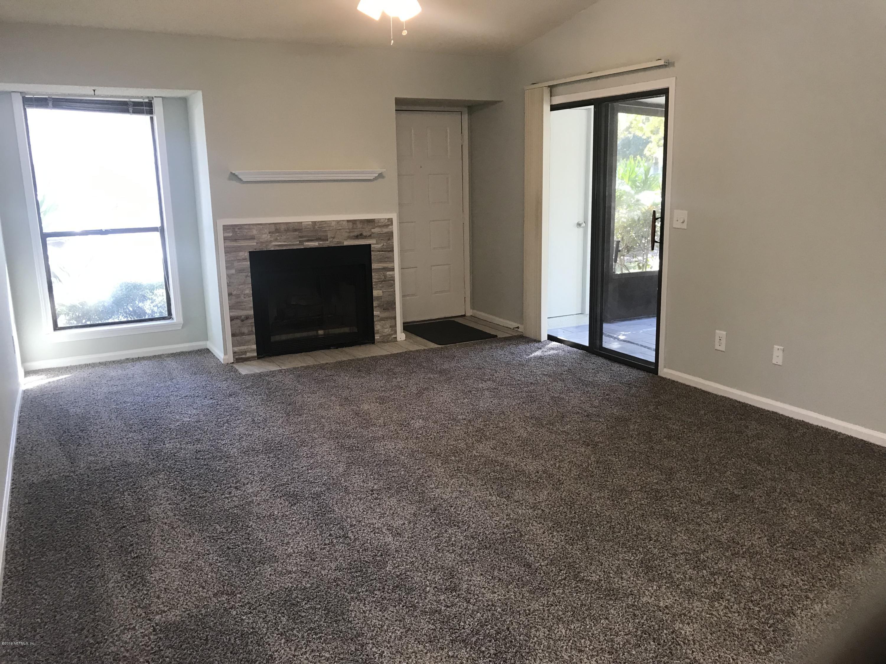 3801 Crown Point Road, Unit 1191 Jacksonville, FL 32257 - Photo 23 of 26 an empty room with windows and fireplace