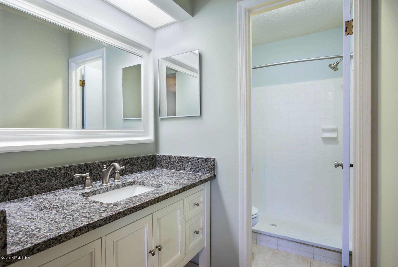 3801 Crown Point Road, Unit 1191 Jacksonville, FL 32257 - Photo 9 of 26 a bathroom with a granite countertop sink and a mirror