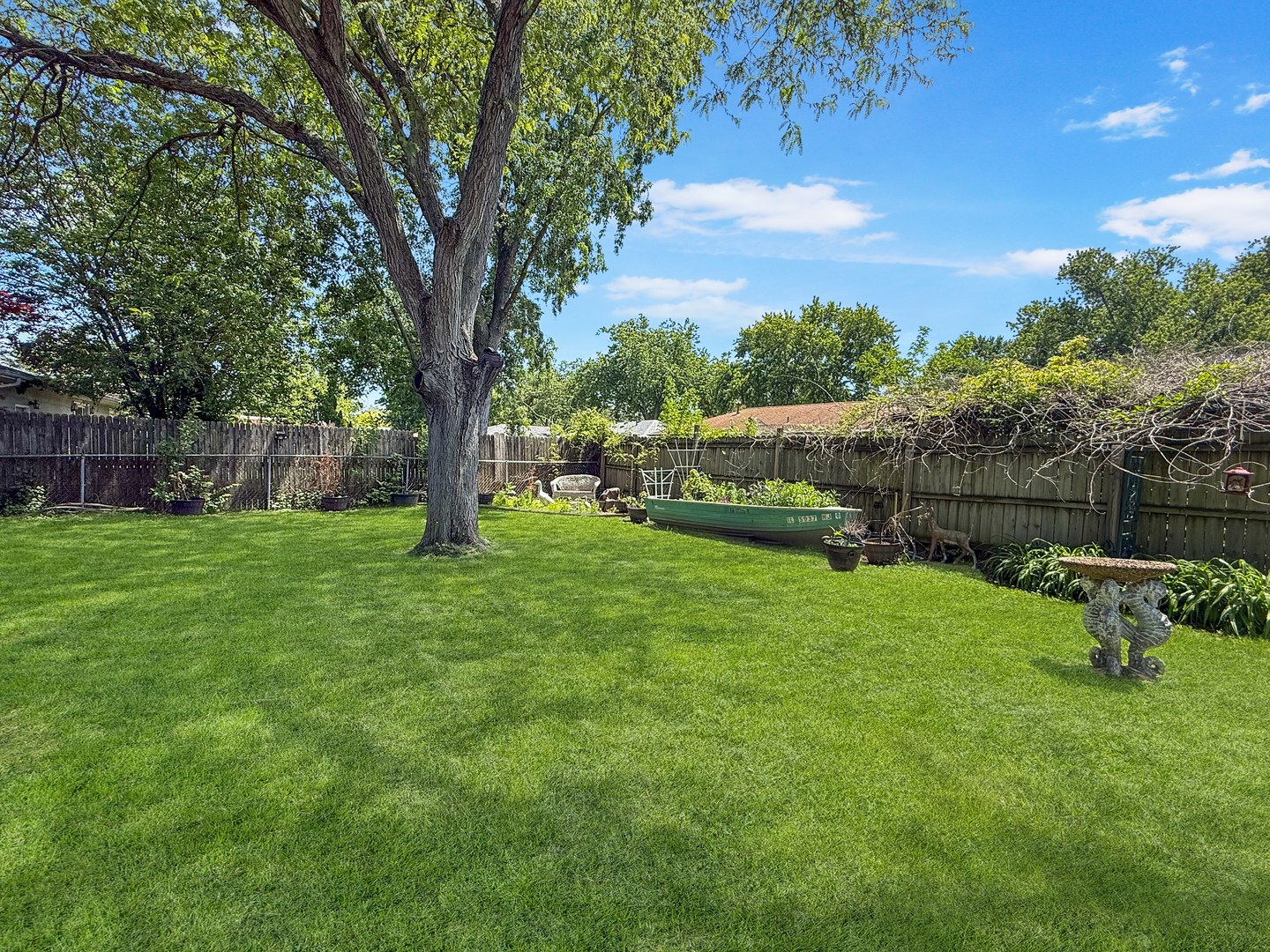814 Pinecrest Drive Rantoul, IL 61866 - Photo 22 of 22 a view of a garden with a tree