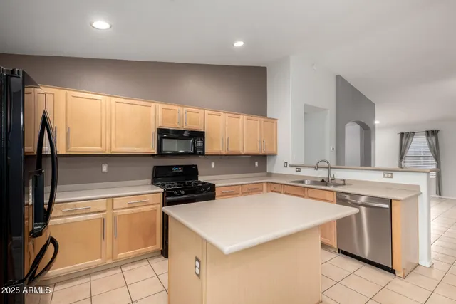 a kitchen with a sink a stove and cabinets