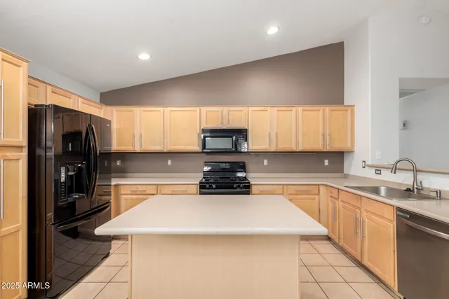 a kitchen with a sink a stove and refrigerator