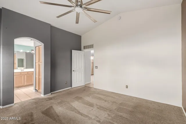 a view of a room with a ceiling fan