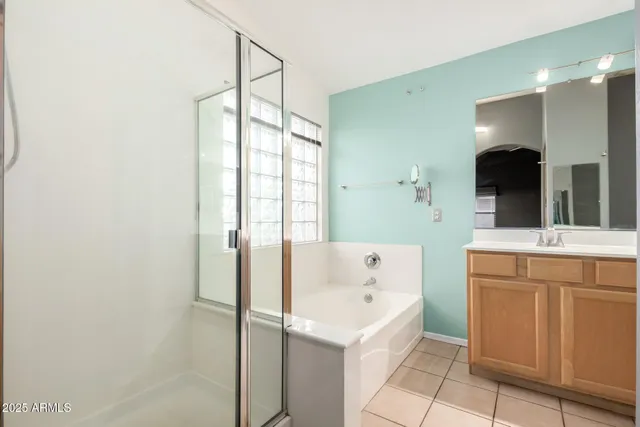 a bathroom with a tub sink and mirror