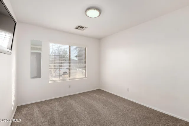 an empty room with a empty space and windows