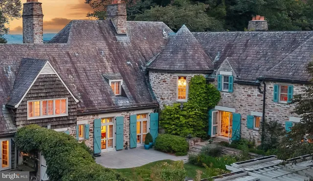 a aerial view of a brick house next to a yard