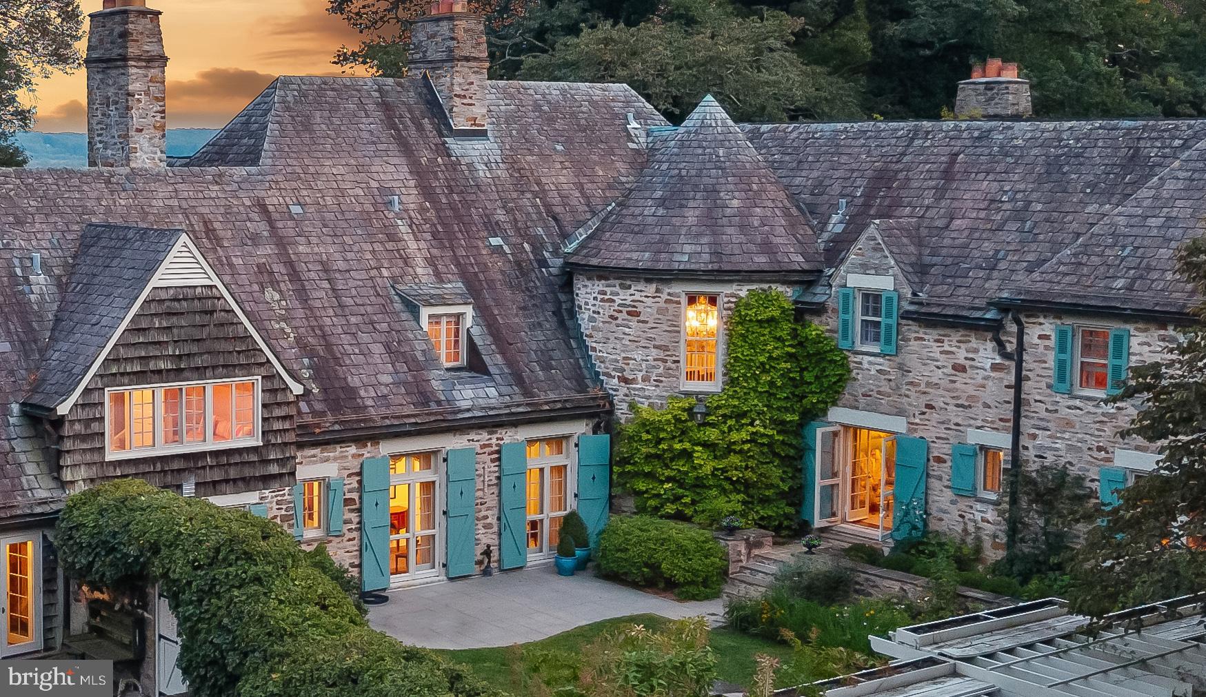 a aerial view of a brick house next to a yard