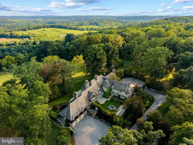 a aerial view of a brick house next to a yard