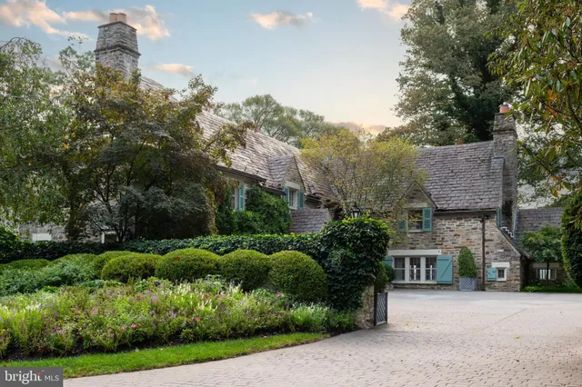 a yellow house with trees in front of it