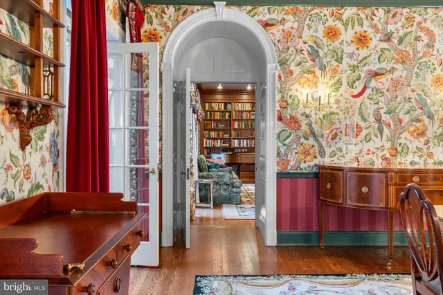 a aerial view of a house with a yard and a large tree