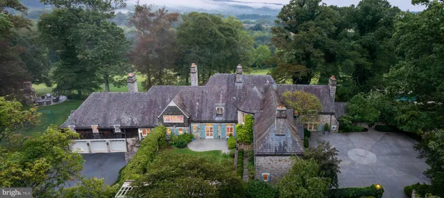 an aerial view of a houses with city view