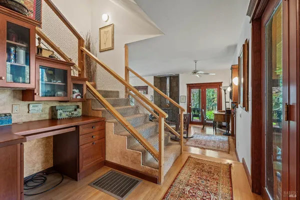a view of an entryway with wooden floor and windows