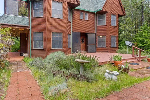 a backyard of a house with outdoor seating