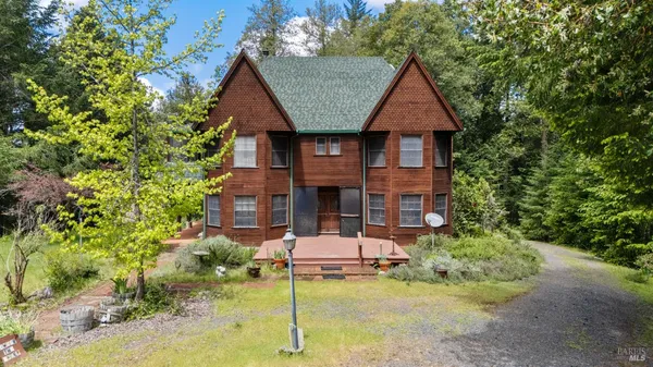 a front view of a house with a yard garage and outdoor seating