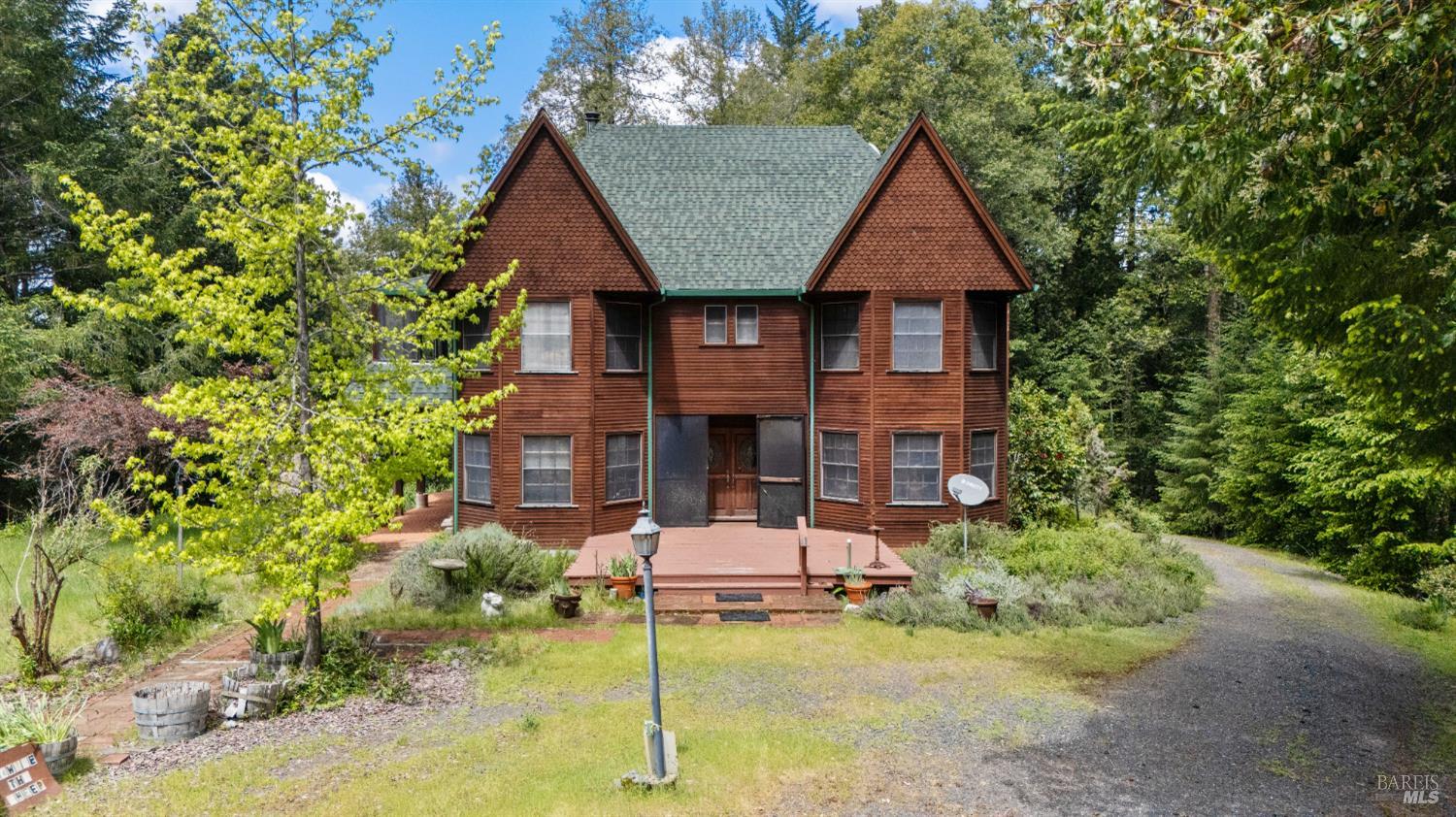 20475 Timber Road Willits, CA 95490 - Photo 30 of 38 a front view of a house with a yard garage and outdoor seating