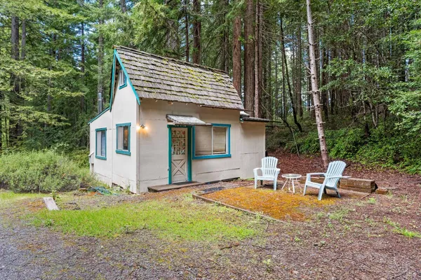 a view of a house with backyard and sitting area