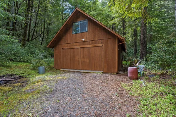 a view of backyard of house with green space