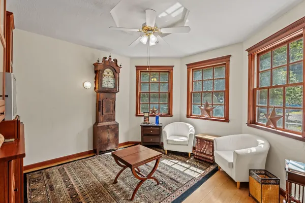 a living room with furniture a fireplace and a window