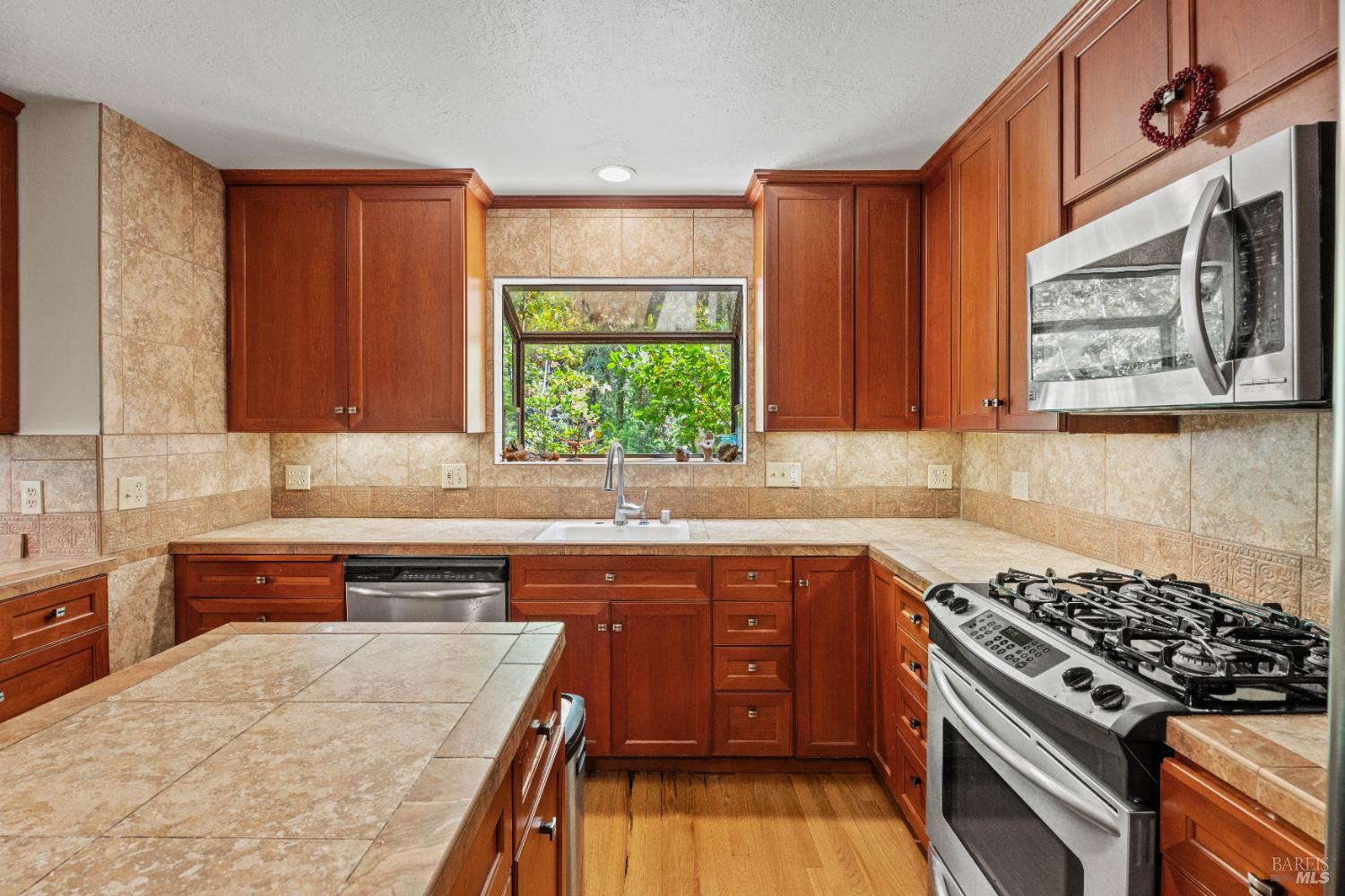 20475 Timber Road Willits, CA 95490 - Photo 6 of 38 a kitchen with stainless steel appliances a stove a sink and a microwave
