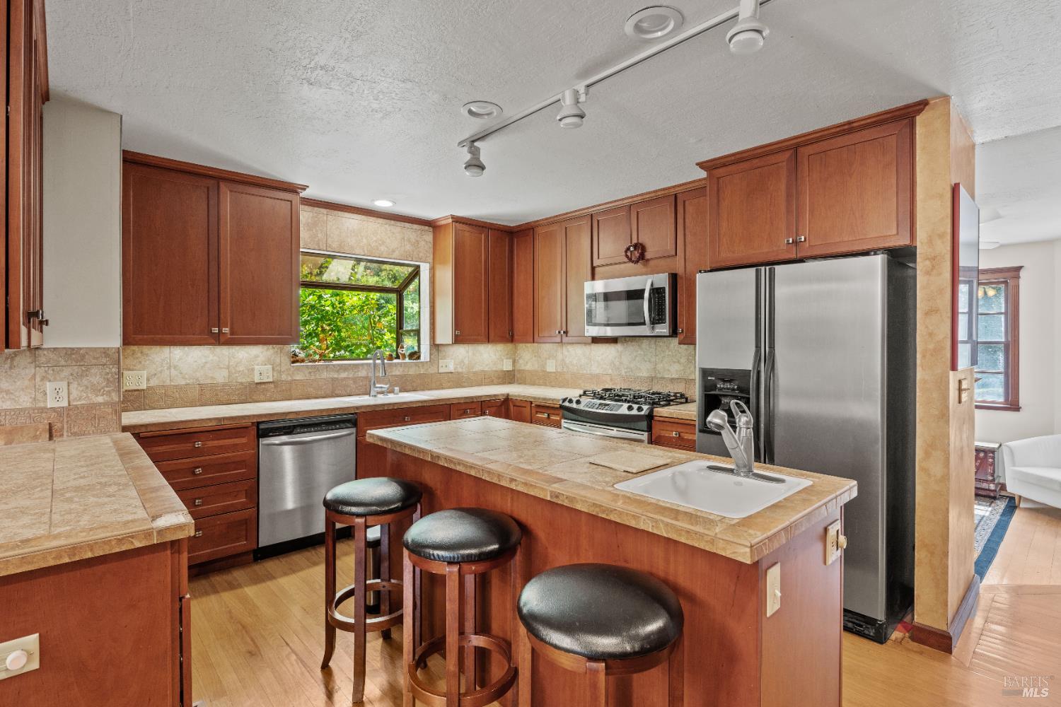 20475 Timber Road Willits, CA 95490 - Photo 7 of 38 a kitchen with a stove a sink a refrigerator and chairs