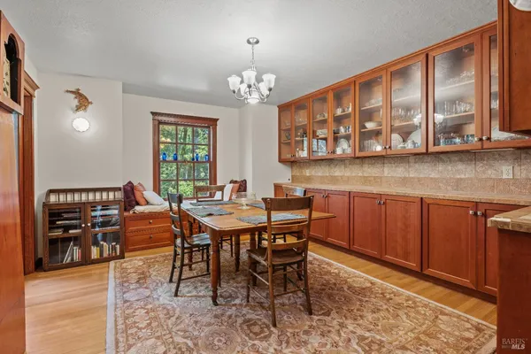 a view of a a dining room with furniture window and wooden floor