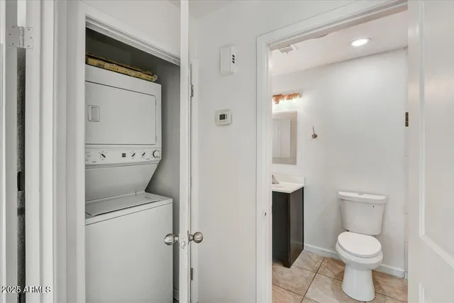 a white toilet sitting next to a bathroom sink