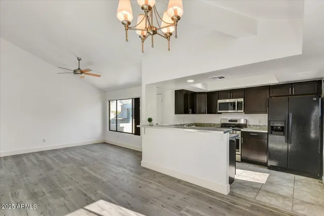 a kitchen with a refrigerator a stove top oven a sink and dishwasher