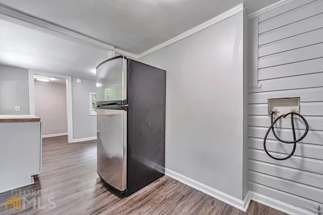 a view of a room with wooden floor and white walls
