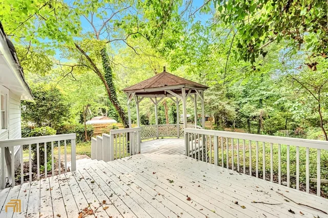 a view of a chair and tables under an umbrella
