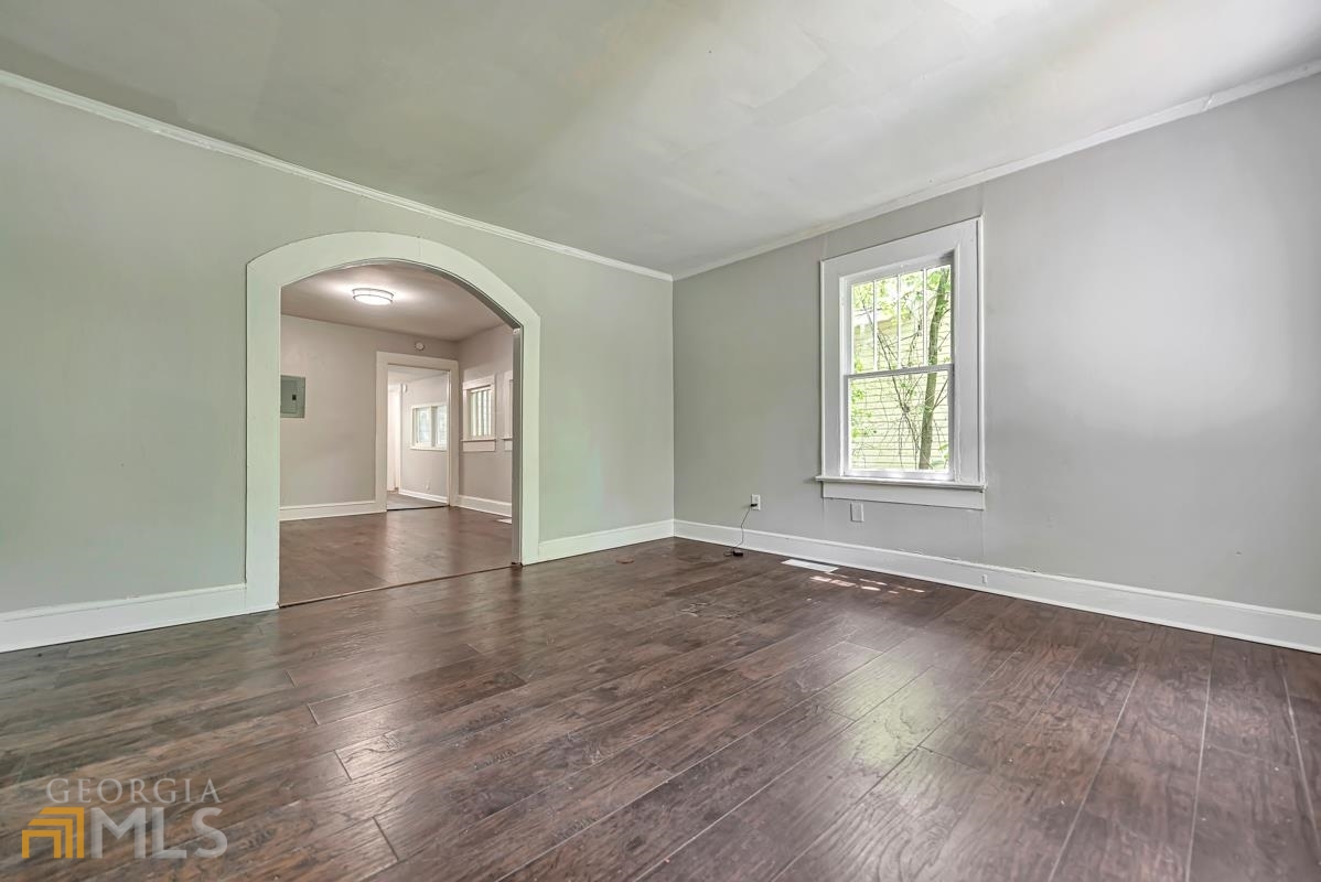 2846 Grand Avenue Southwest Atlanta, GA 30315 - Photo 5 of 19 an empty room with wooden floor and windows