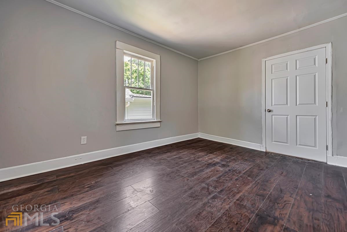 2846 Grand Avenue Southwest Atlanta, GA 30315 - Photo 8 of 19 a view of an empty room with wooden floor and a window