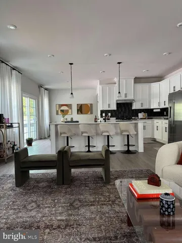 a living room with furniture and kitchen view