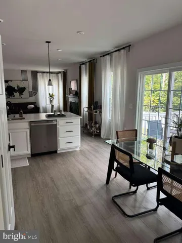a kitchen with a table chairs stove and cabinets