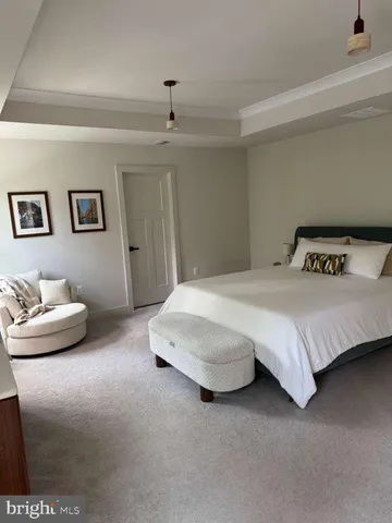 a bedroom with a large bed and a couch