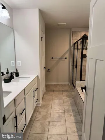 a bathroom with a glass shower door