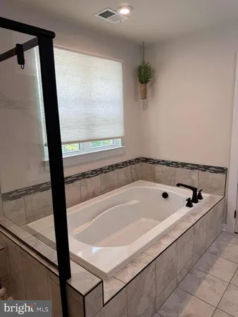 a bedroom with a bed and a television