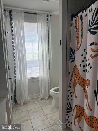 a bedroom with a large bed and large window