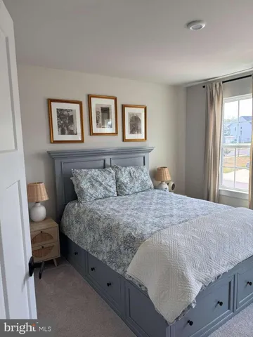 a bedroom with a bed and painting on the wall