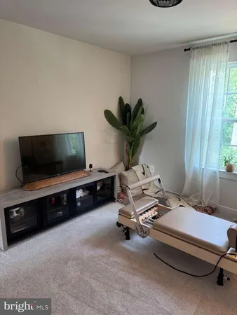 a living room with a couch and a chandelier
