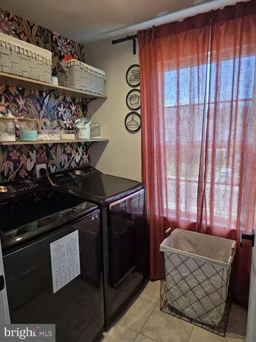 a view of an empty room with wooden cabinet and stairs