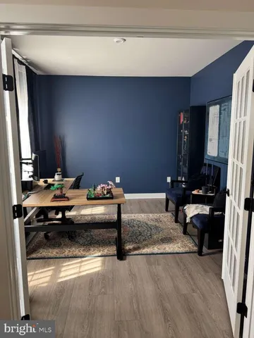 a bedroom with a bed and a flat tv screen on a dresser