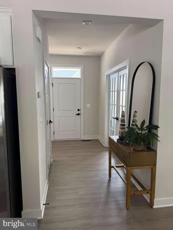 a view of entryway with a potted plant and wooden floor
