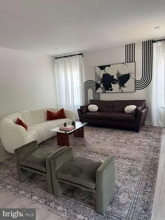 a living room with furniture and a lamp