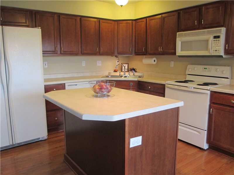 5 Castle View Drive McKees Rocks, PA 15136 - Photo 6 of 25 a kitchen with a sink a stove a microwave and wooden cabinets