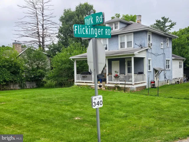 a view of a house with a yard porch and sitting area
