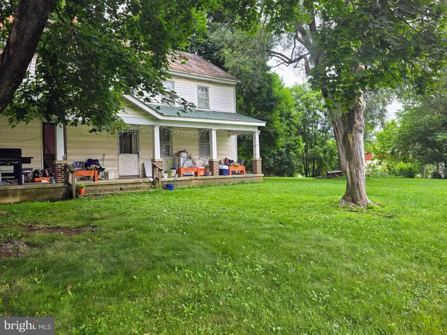 a front view of house with yard and outdoor seating