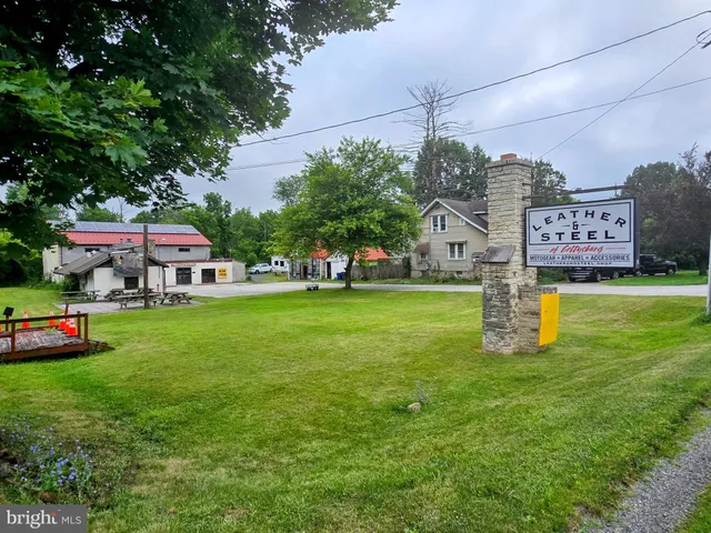 a yellow and red houses sitting in the grass