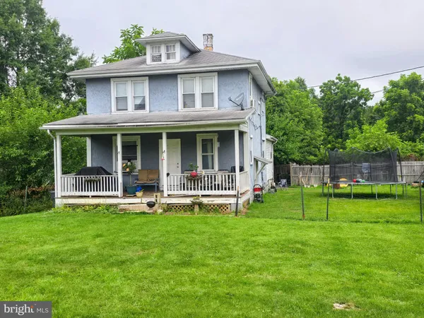 a front view of house with a garden and porch