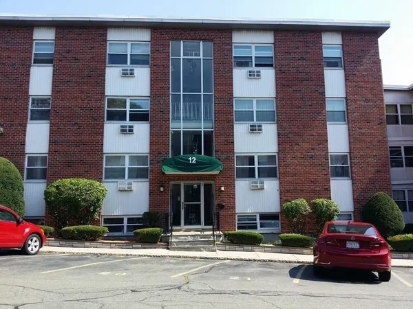 a car parked in front of a brick building