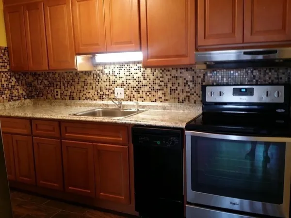 a kitchen with stainless steel appliances a refrigerator and a stove top oven