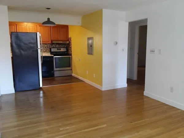 an empty room with a fireplace and windows
